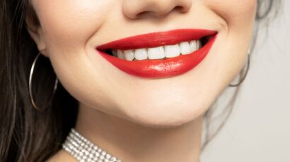 Hollywood smile close-up with bright white teeth and red lipstick