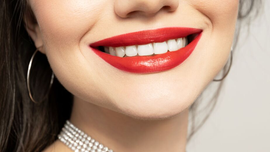 Hollywood smile close-up with bright white teeth and red lipstick