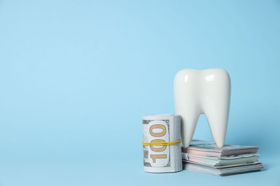 Dental implants cost in Turkey 2026 concept with tooth model and cash