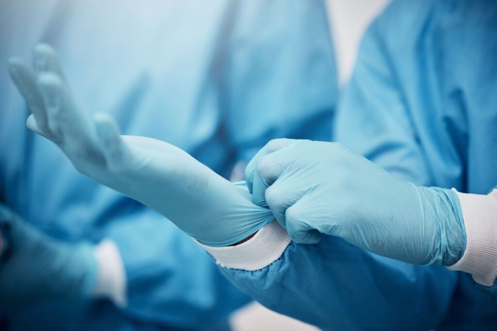Doctor with gloves in hospital ready for surgery, operation or procedure