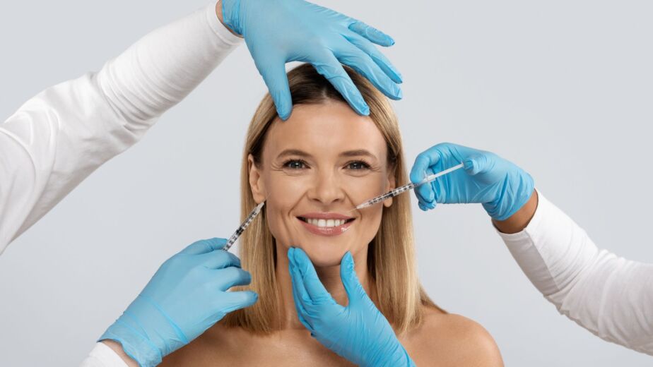 Doctor performing a facial filler injection during a fat transfer vs fillers consultation in Turkey