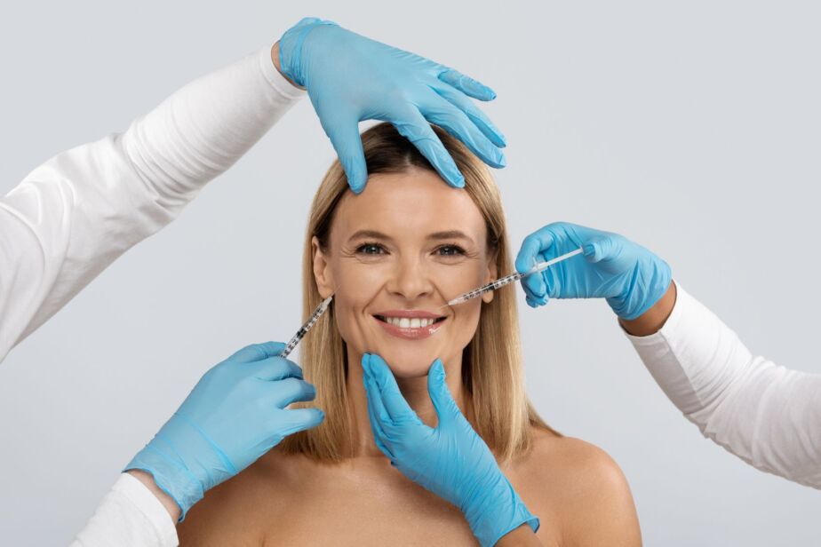 Doctor performing a facial filler injection during a fat transfer vs fillers consultation in Turkey