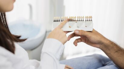Patient and dentist comparing dental shade samples during a Hollywood Smile consultation for veneers and zirconia crowns in Turkey