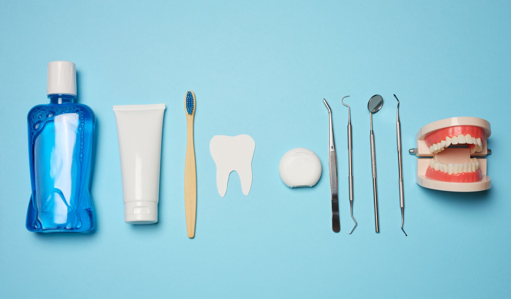 Oral hygiene tools and teeth model representing poor oral health prevention
